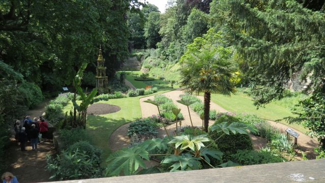 Formal garden with paths surrounded by trees.